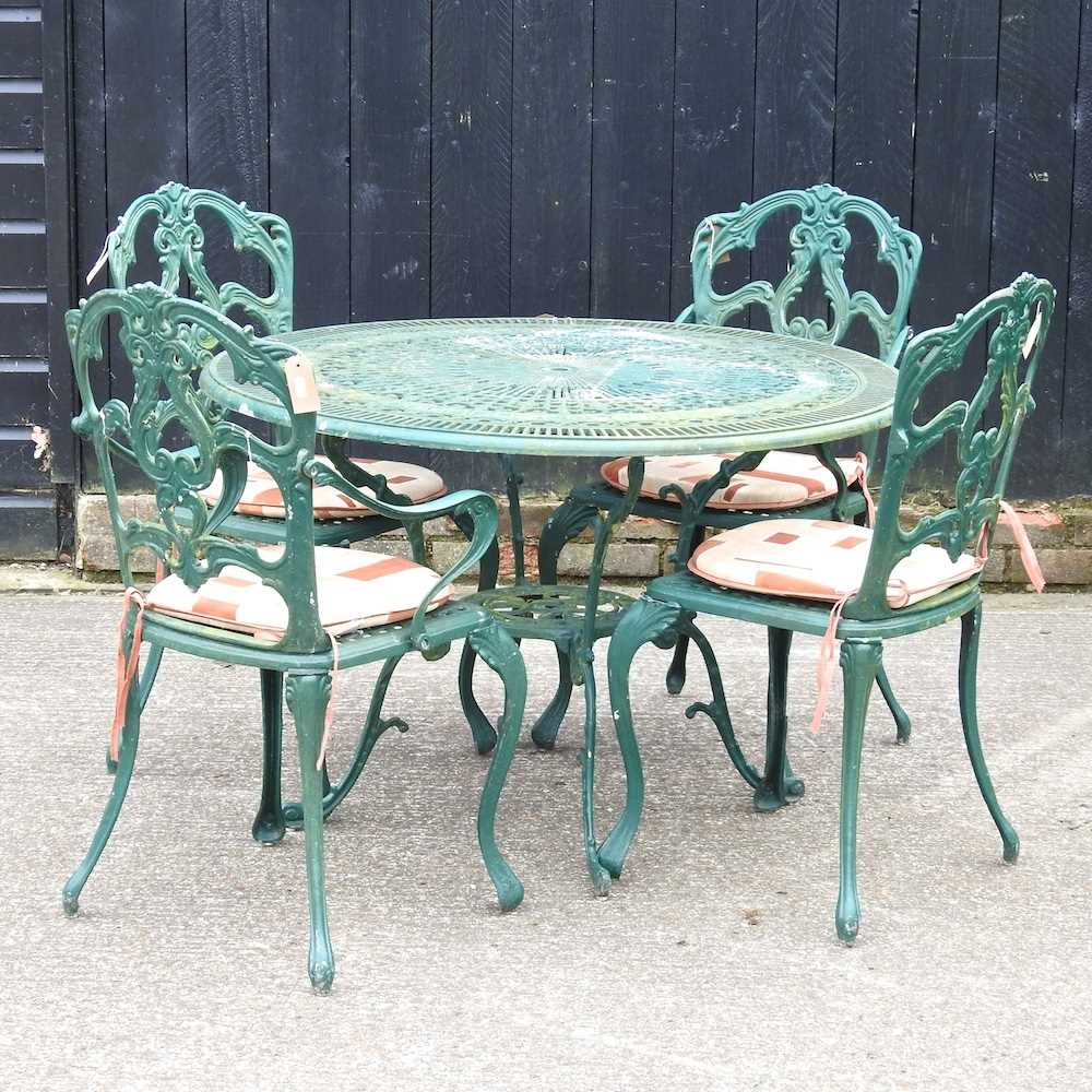 A green painted garden table, together with four matching chairs, with cushions
