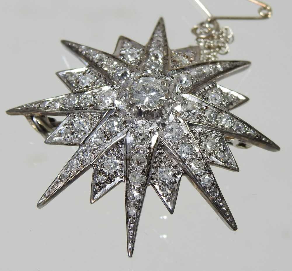 A diamond target brooch, of graduated star shape, with a pin back, unmarked, 11.8g, 4cm wide - Image 2 of 4