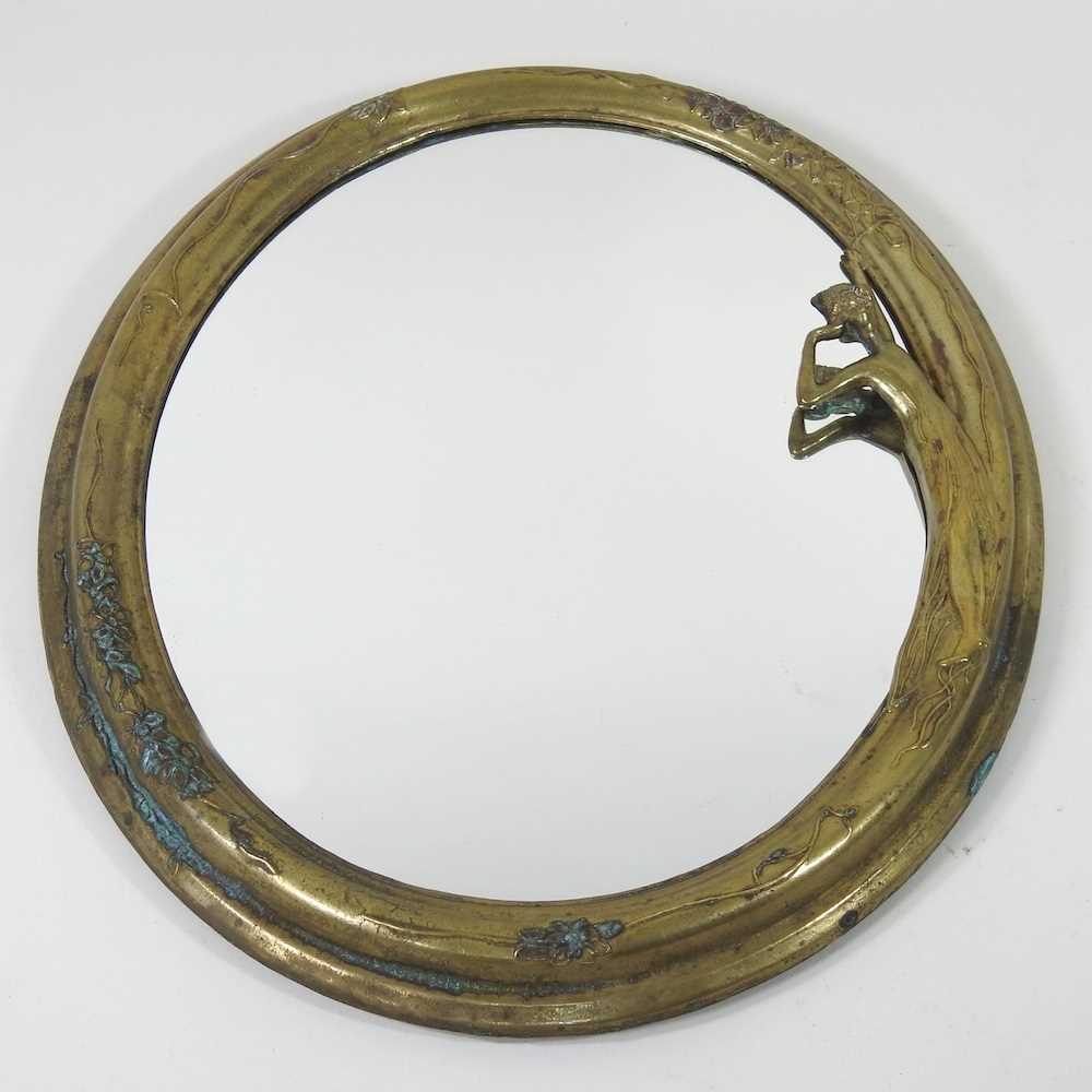 An Art Nouveau brass framed easel mirror, decorated in relief with a lady, 35 x 28cm