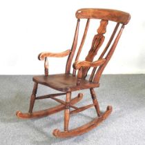 An early 20th century elm seated splat back rocking chair