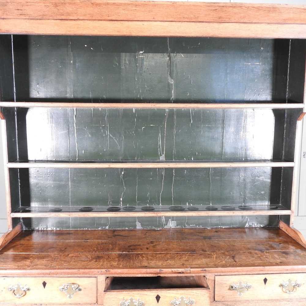 An 18th century Welsh oak dresser, having a boarded back, over an arrangement of short drawers and - Image 5 of 7