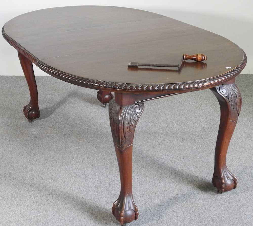 An early 20th century wind out extending dining table, of oval shape, on a claw and ball feet, - Image 3 of 8