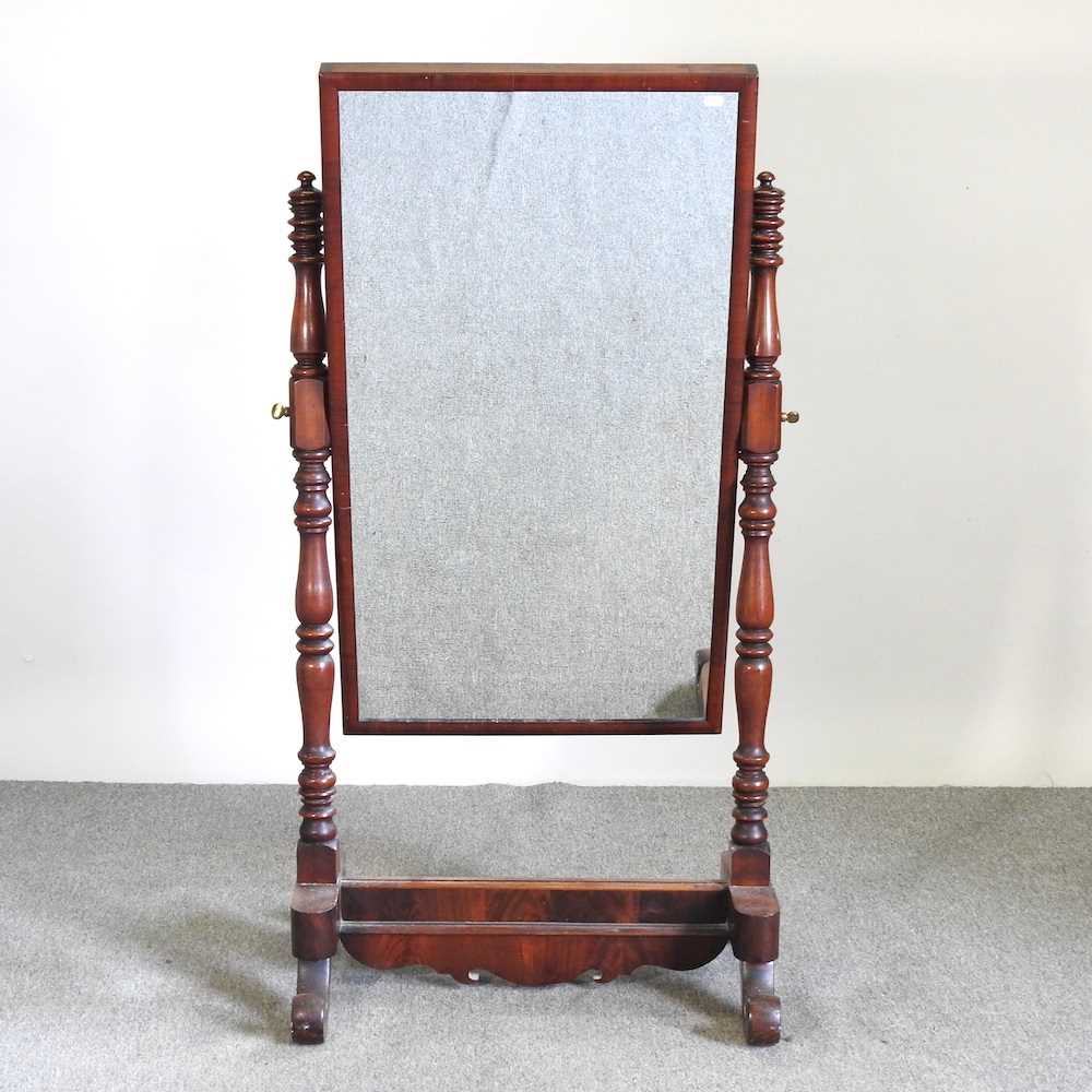 A Victorian mahogany cheval mirror, with turned supports, on scrolled base 72w x 55d x 140h cm
