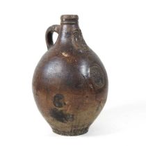 A 17th century German salt glazed stoneware bellarmine or Bartmann krug, of plain shape with a