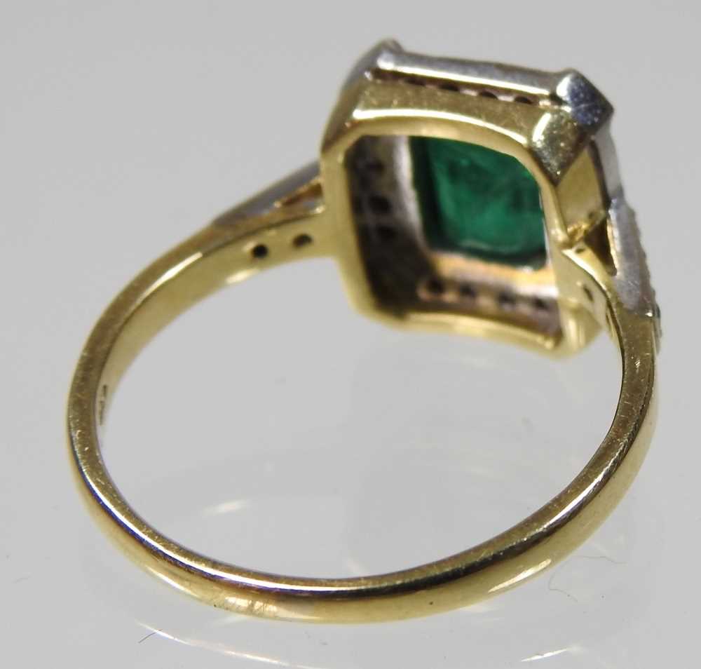 An unmarked emerald and diamond cluster ring, of Art Deco design, with a central baguette cut - Image 4 of 4