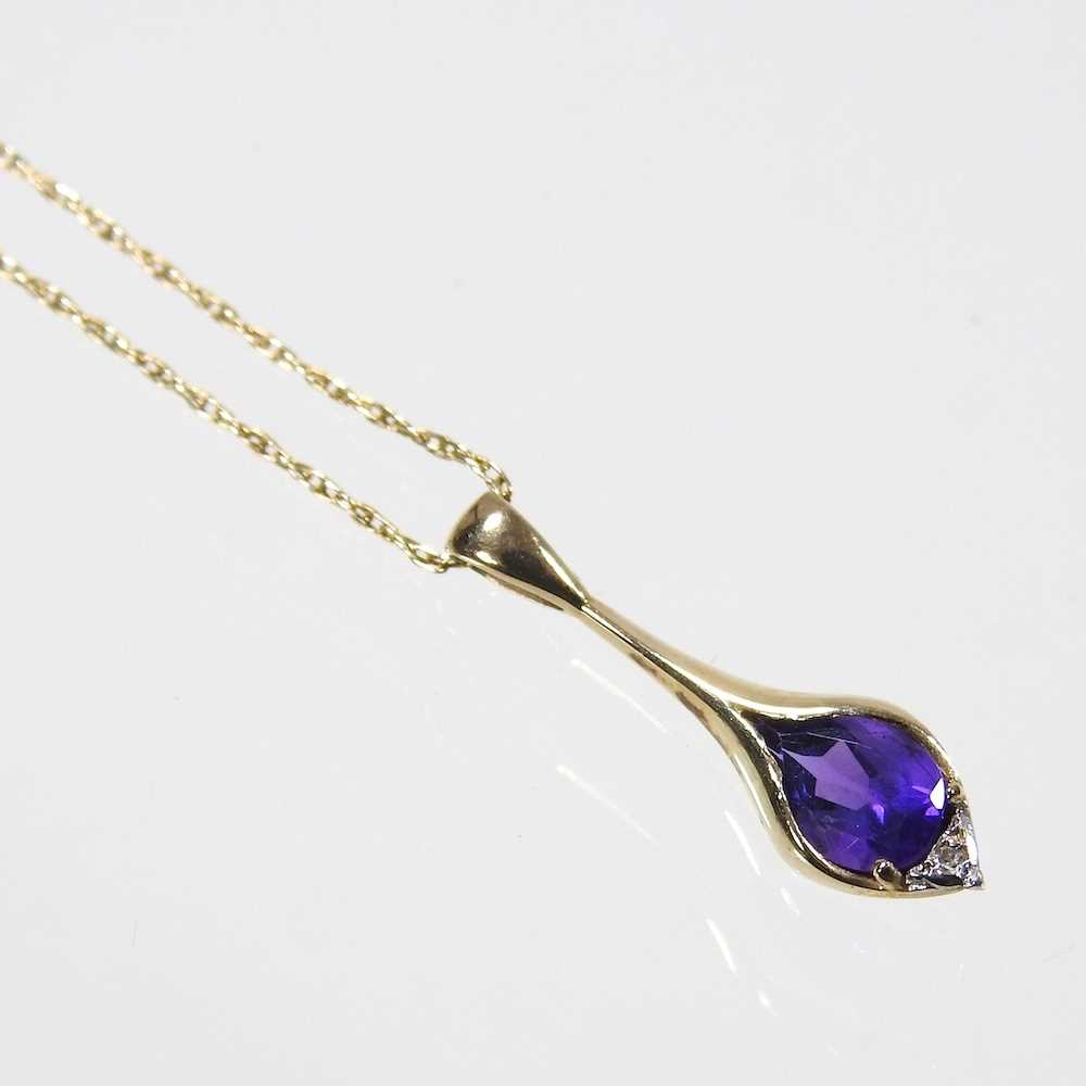 A 9 carat gold gem set pendant necklace, on a fine chain, 48cm long, 1.9g, cased