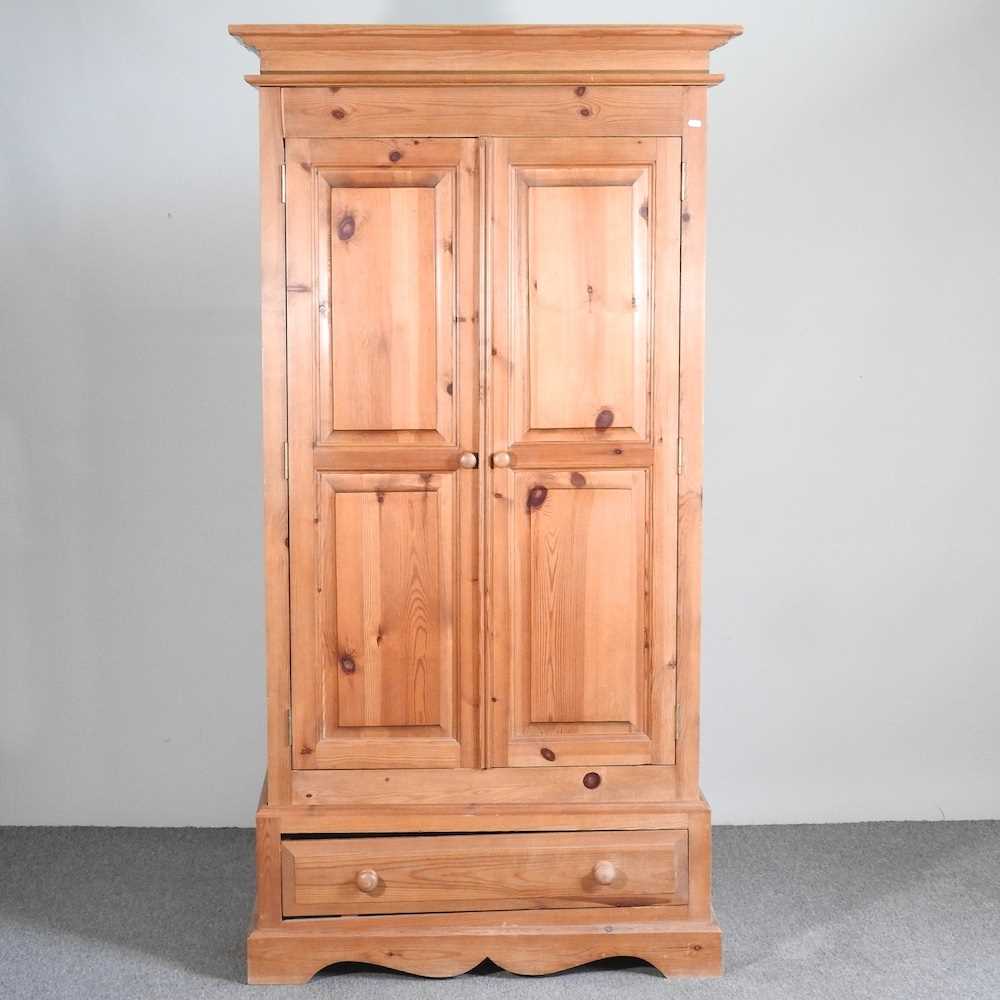 A modern pine double wardrobe, with a drawer below 103w x 61d x 200h cm