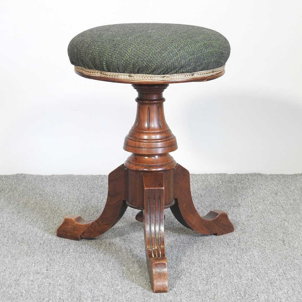 A Victorian walnut revolving piano stool, stamped H Brooks & Co Ltd, 5546 to the underside