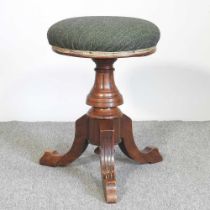A Victorian walnut revolving piano stool, stamped H Brooks & Co Ltd, 5546 to the underside