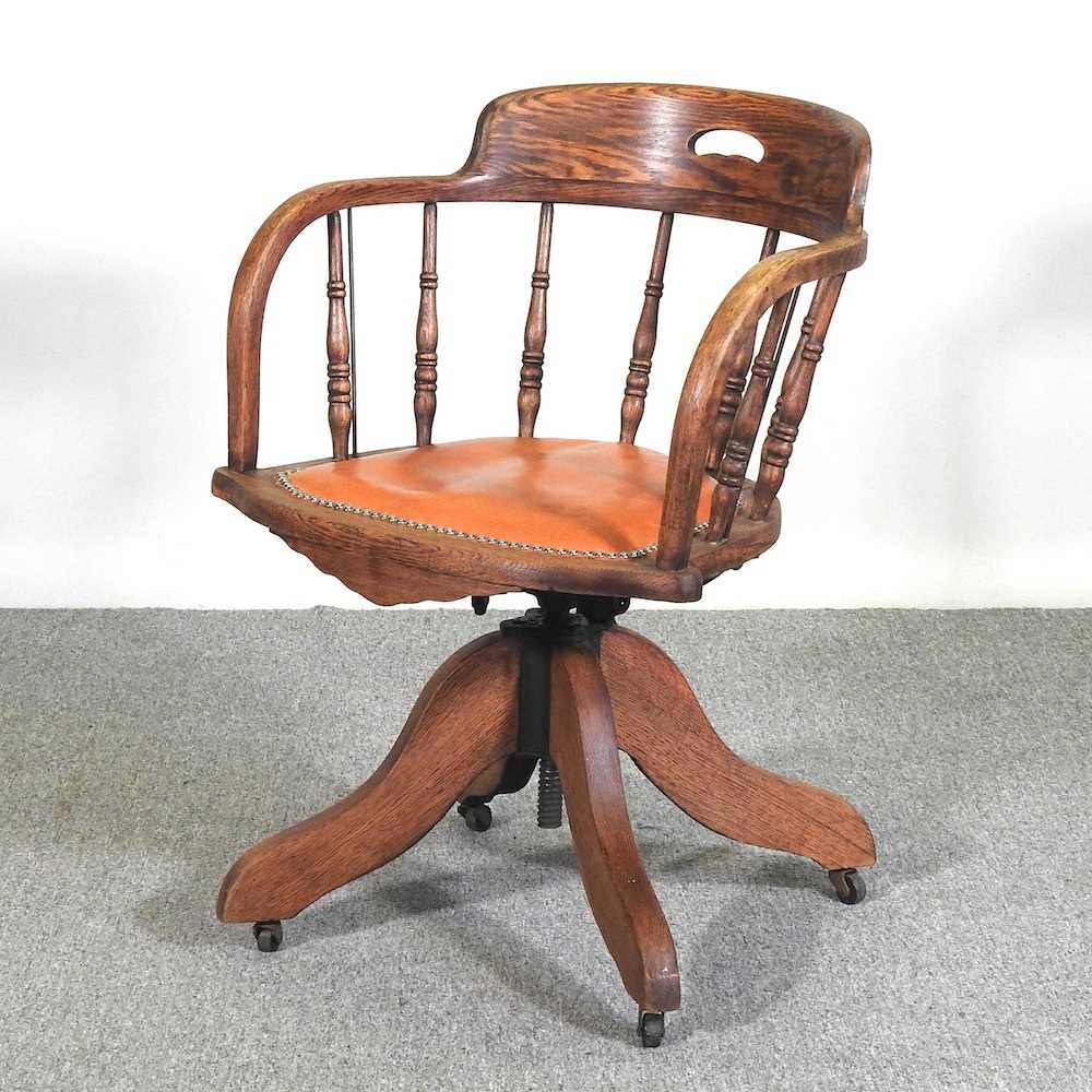 An early 20th century oak swivel desk chair
