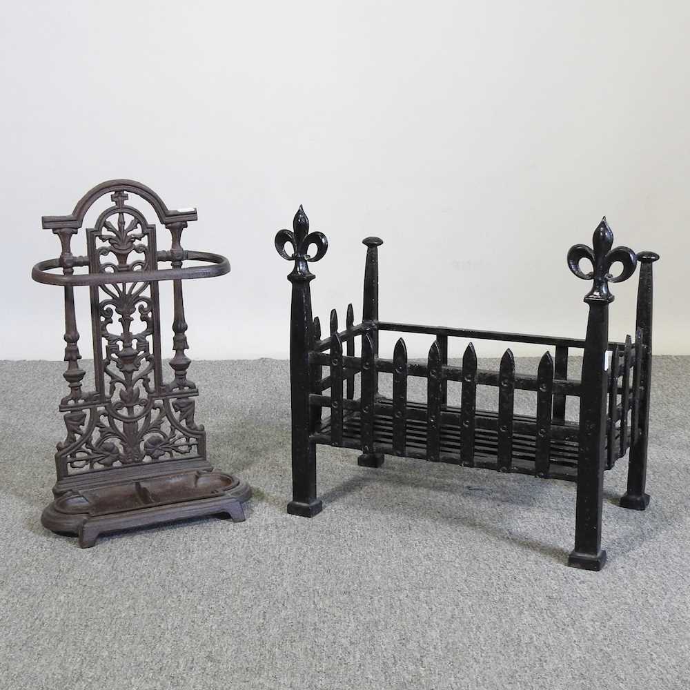 A cast iron fire grate, 47cm wide, together with a cast iron stick stand (2)