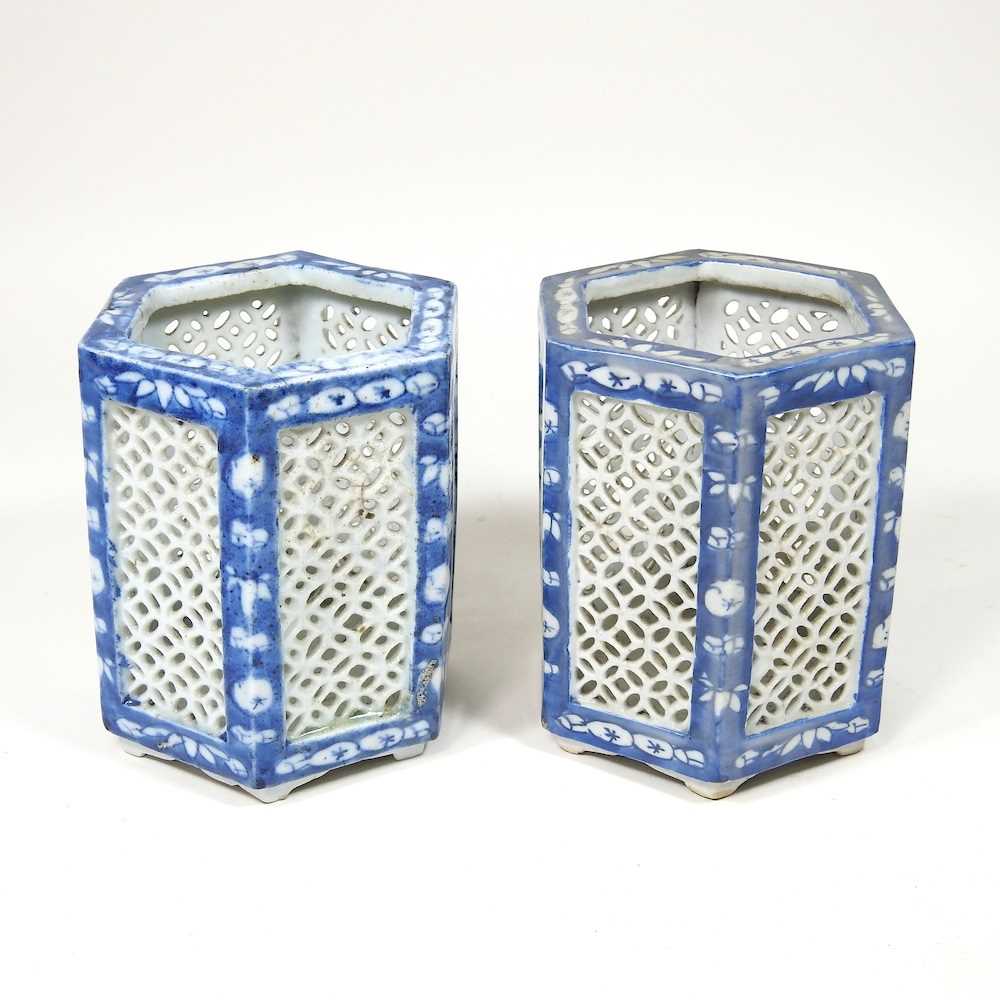 A pair of Chinese porcelain blue and white tea light holders, 20th century, with pierced panels,