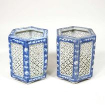 A pair of Chinese porcelain blue and white tea light holders, 20th century, with pierced panels,