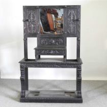 A 19th century heavily carved dark oak hall stand, with a mirrored back 111w x 42d x 172h cm