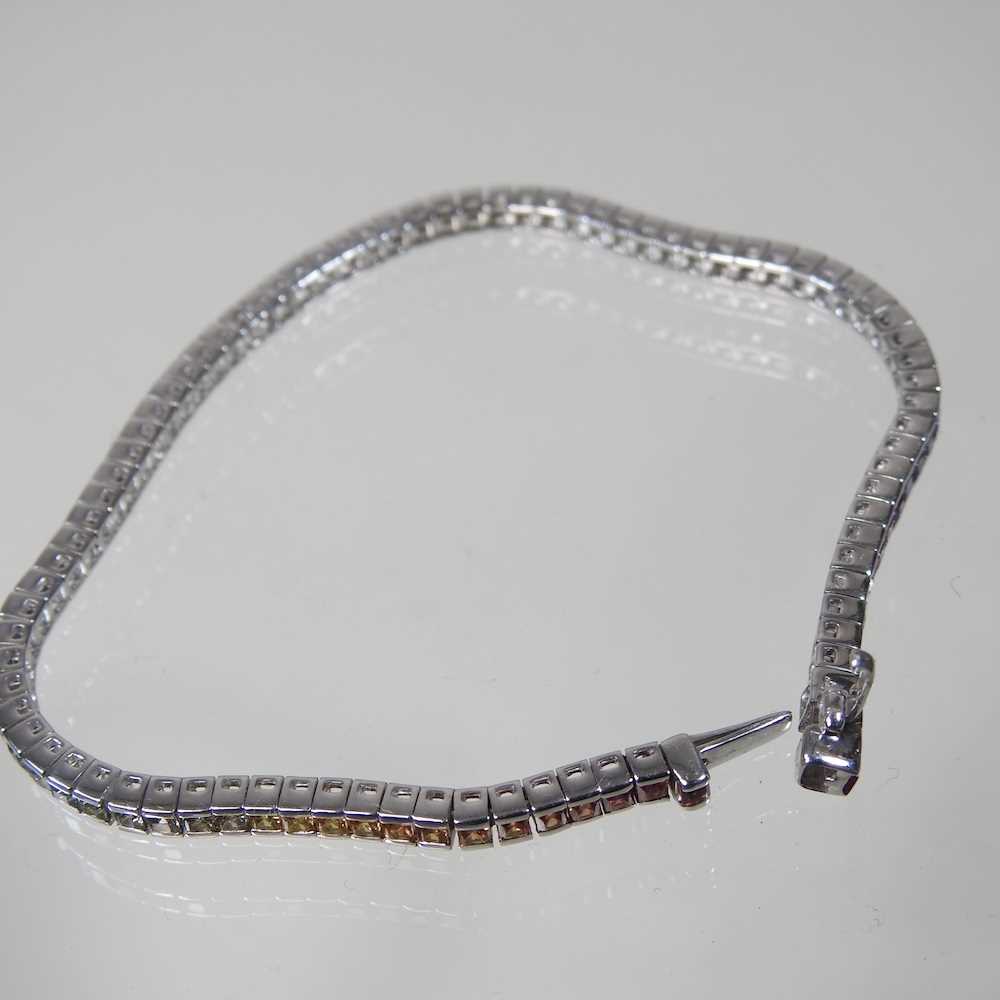 A 9 carat white gold, fancy sapphire and diamond line bracelet, set with a single row of - Image 3 of 3