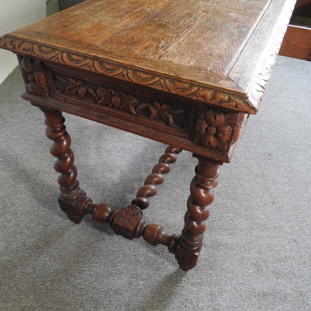 An early 20th century carved oak writing table, on spirally turned supports 120w x 60d x 75h cm - Image 2 of 5