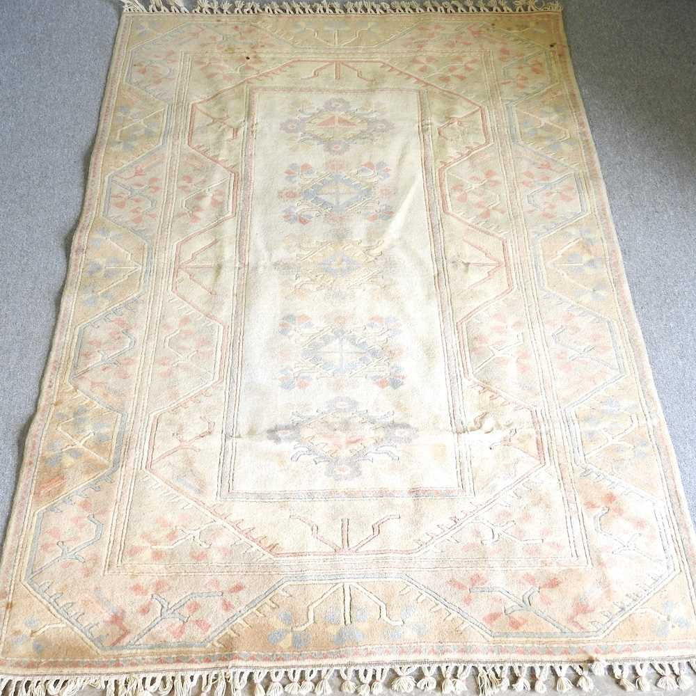 A Turkish woollen carpet, with all over designs on a cream ground, 280 x 190cm