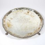 A 20th century silver salver, of circular shape, with a gadrooned border, on hoof feet, London 1962,