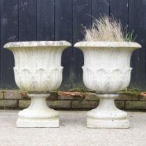 A pair of cast stone garden urns, of pedestal form, 57cm high (2)