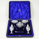 A silver plated condiment set, comprising a pair of salts, mustard, a pair of peppers and spoons, in