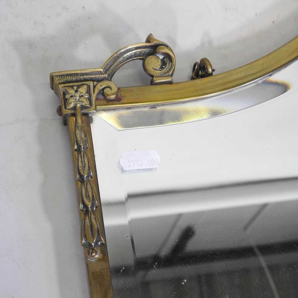 An early 20th century brass framed wall mirror, 46 x 67cm, together with a collection of stair rods - Image 3 of 6