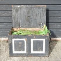 An antique cast iron safe, planted with flowers, 61cm wide