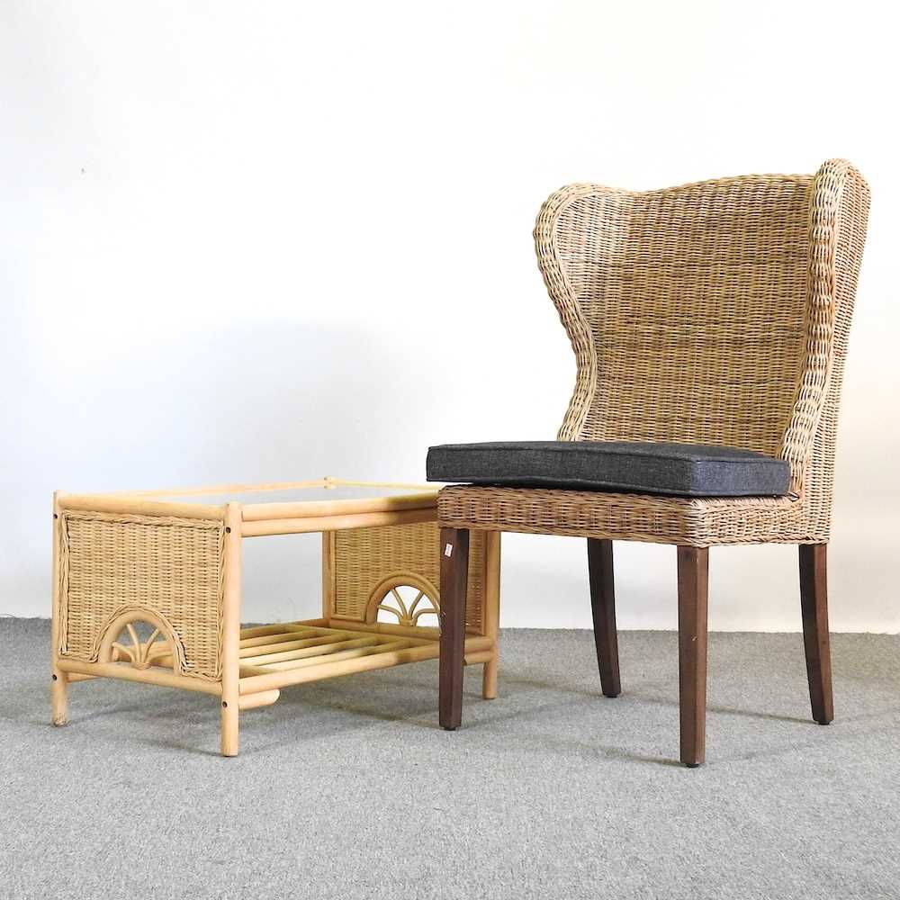 A modern wicker chair, together with a glass top coffee table (2)