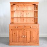 A modern pine dresser, with a boarded back 128w x 51d x184h cm