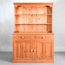 A modern pine dresser, with a boarded back 128w x 51d x184h cm