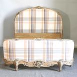 A later 20th century French limed and cream check upholstered double bedstead, with a slatted wooden