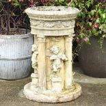 A large cast stone font, decorated with classical columns and cherubs, 80cm high
