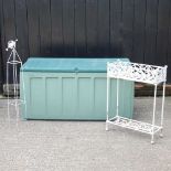 A white painted metal planter, together with a white plant support and a large garden storage box (