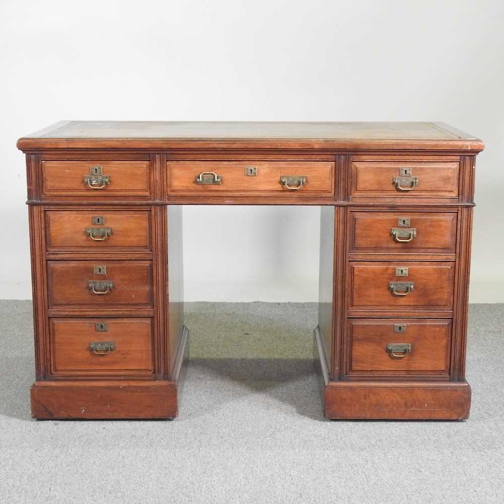 An Edwardian walnut pedestal desk, with an inset top, containing nine short drawers 122w x 68d x 78h