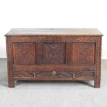 An 18th century carved oak dowry chest, with a hinged lid 137w x 59d x 79h cm