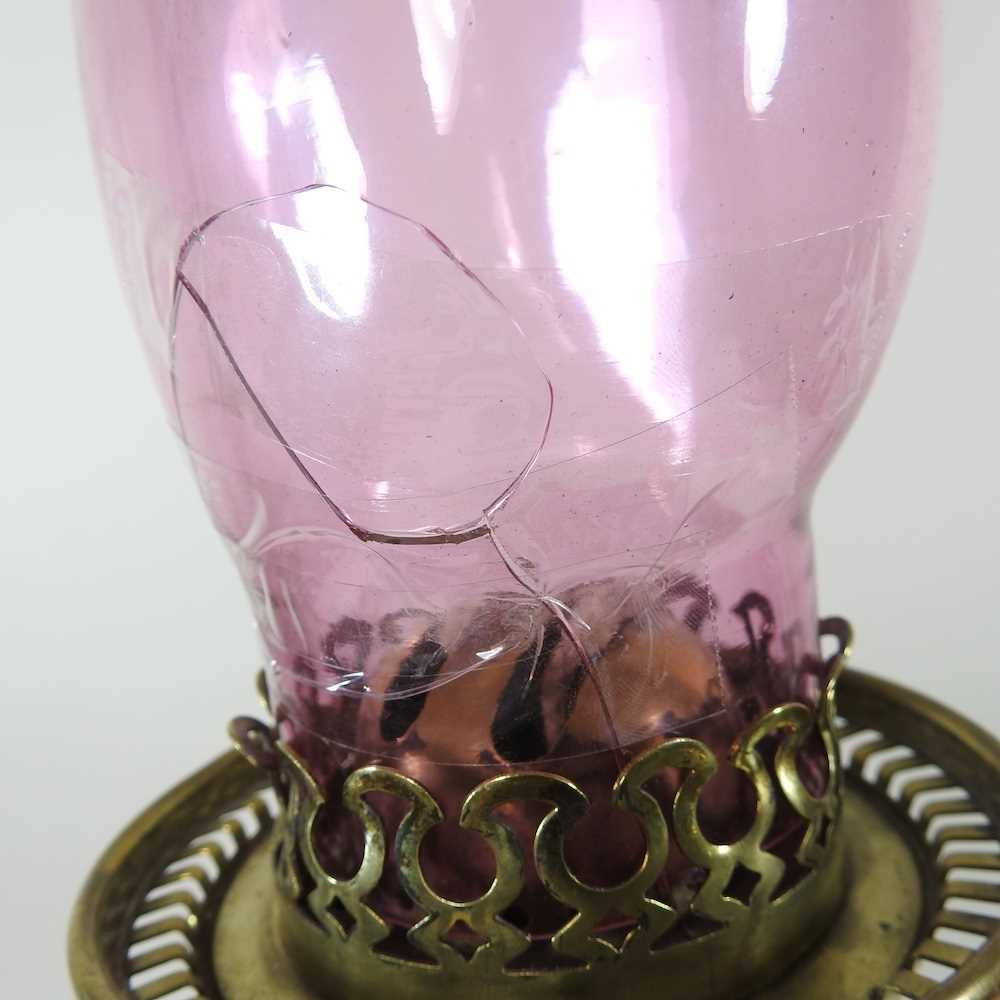 A 19th century brass oil lamp, with a cranberry glass chimney, 65cm high Cranberry chimney is - Image 3 of 6