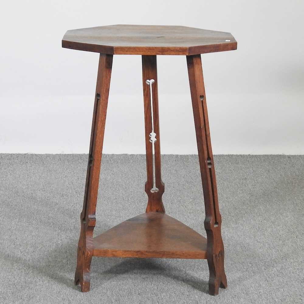 An Art Nouveau oak occasional table, with an octagonal top, on a splayed base 51w x 51d x 75h cm