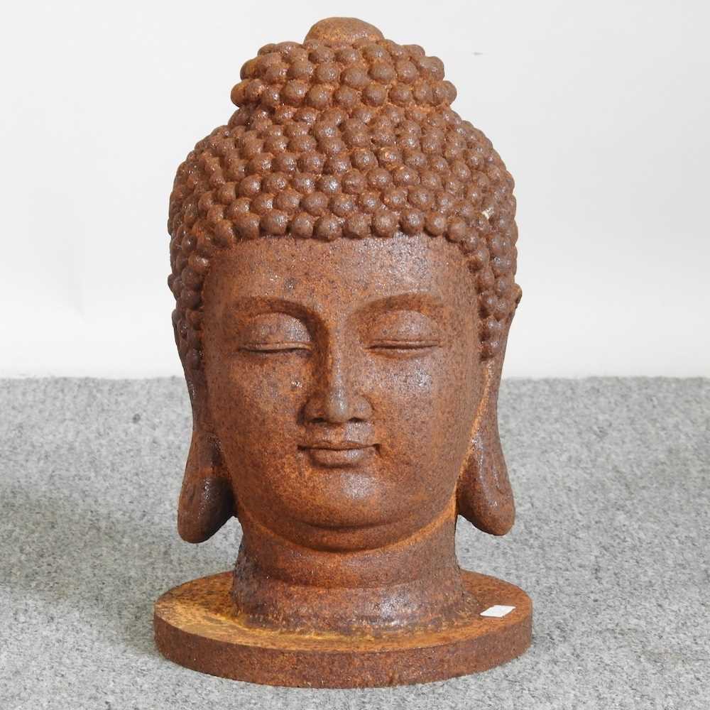 A cast metal head of Buddha, 32cm high