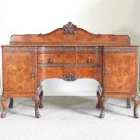 A large good quality 1920's walnut pedestal sideboard, with blind fret carved decoration, having a