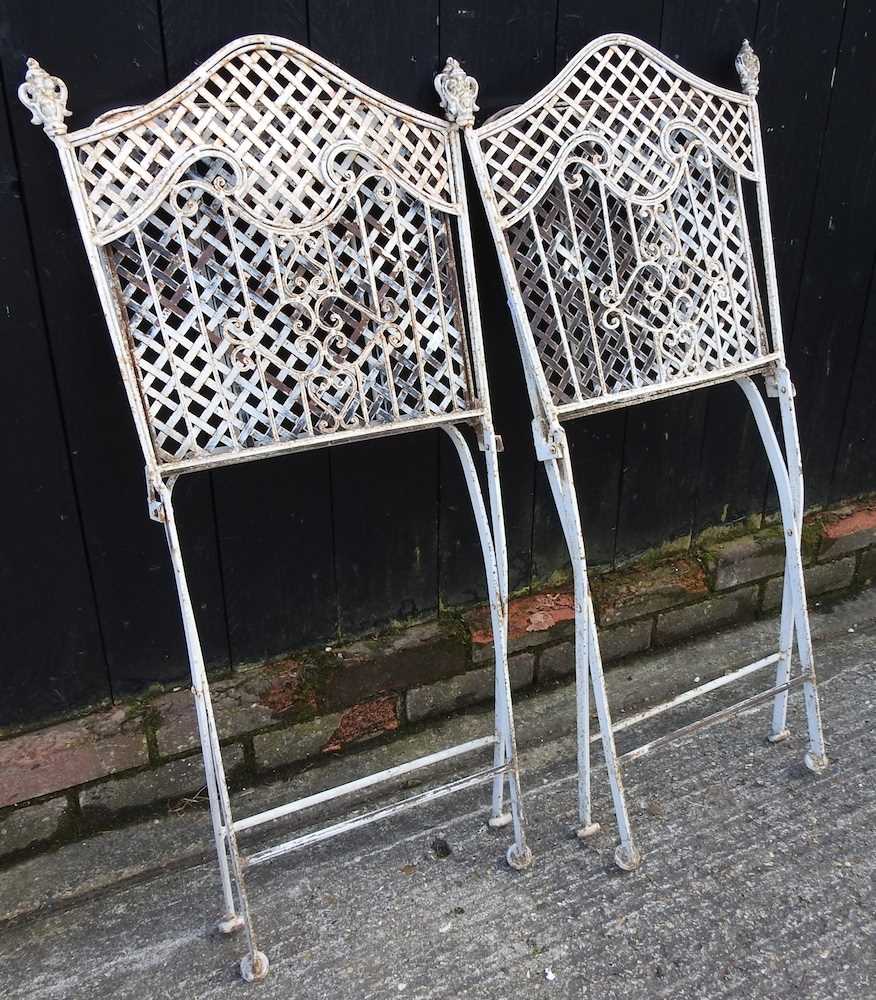 A cream painted metal circular garden table, together with a pair of folding chairs (3) 76w x 78h - Image 2 of 3