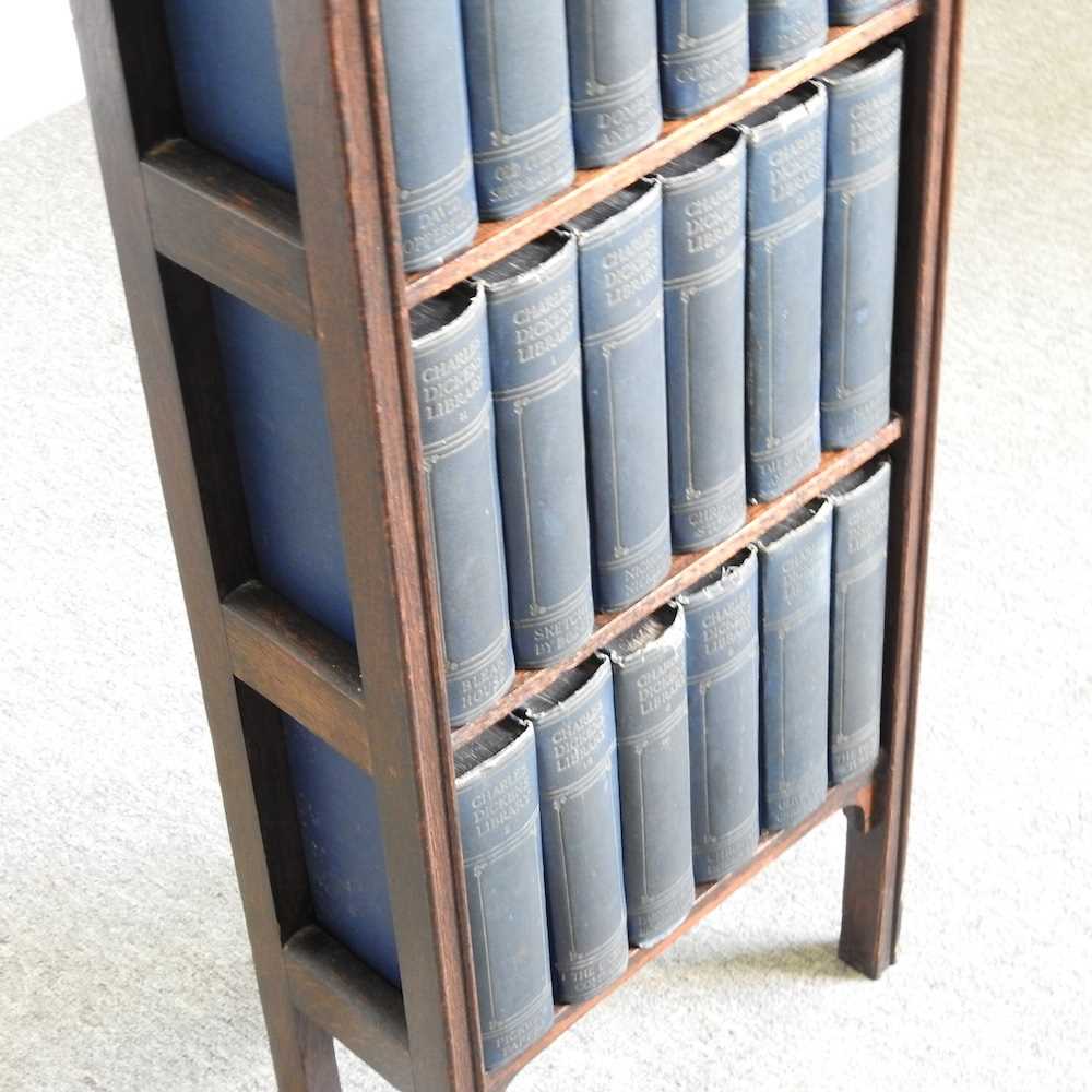An early 20th century oak bookcase, containing a collection of Charles Dickens books 34w x 16d x 95h - Image 4 of 4