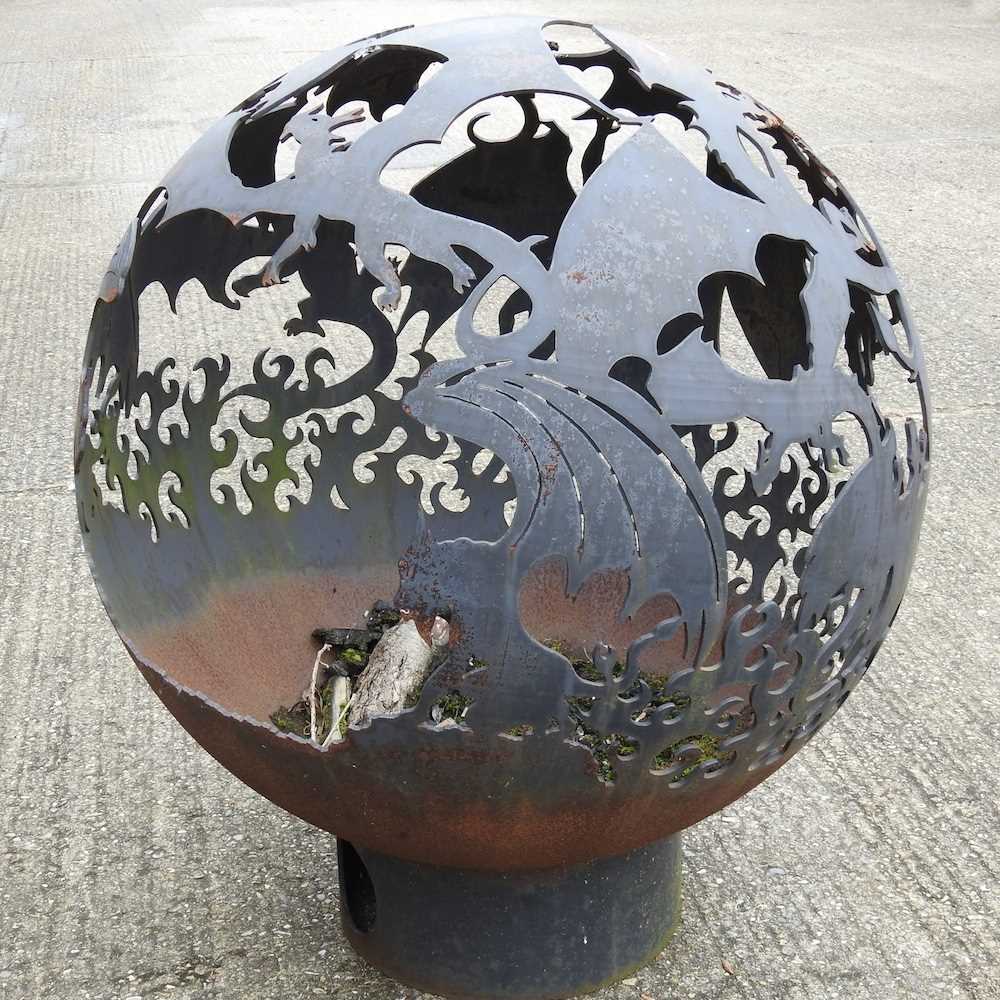 A hand made steel globe firepit, decorated with dragons, on stand, 102cm high