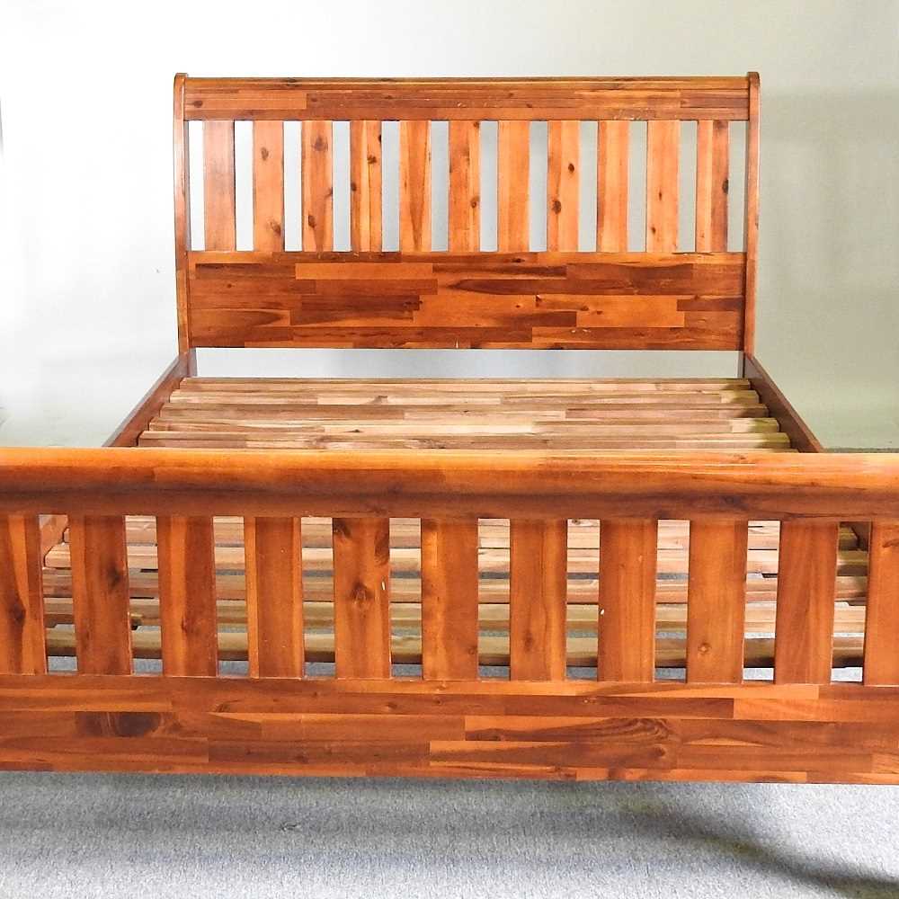 A modern Morris Furniture double bedstead, with a slatted wooden base 145cm wide
