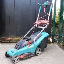 A green Bosch electric lawn mower