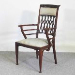 An Edwardian carved mahogany elbow chair