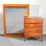 A small mid 20th century walnut bow front chest of drawers, together with a modern wall mirror, 90 x