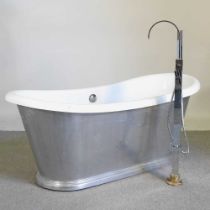 A free standing roll top bath, with a shower attachment 163l x 71w x 67h cm Overall condition is