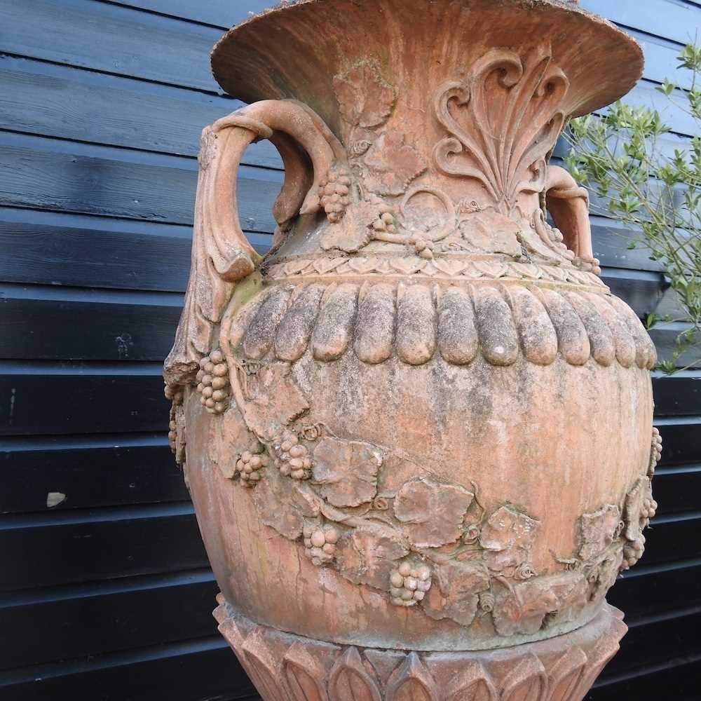 A very large terracotta stone garden urn and cover, of twin handled form, relief decorated with - Image 4 of 7