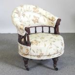A Victorian cream upholstered ship's swivel armchair, on turned legs, kite mark to base 60w x 60d