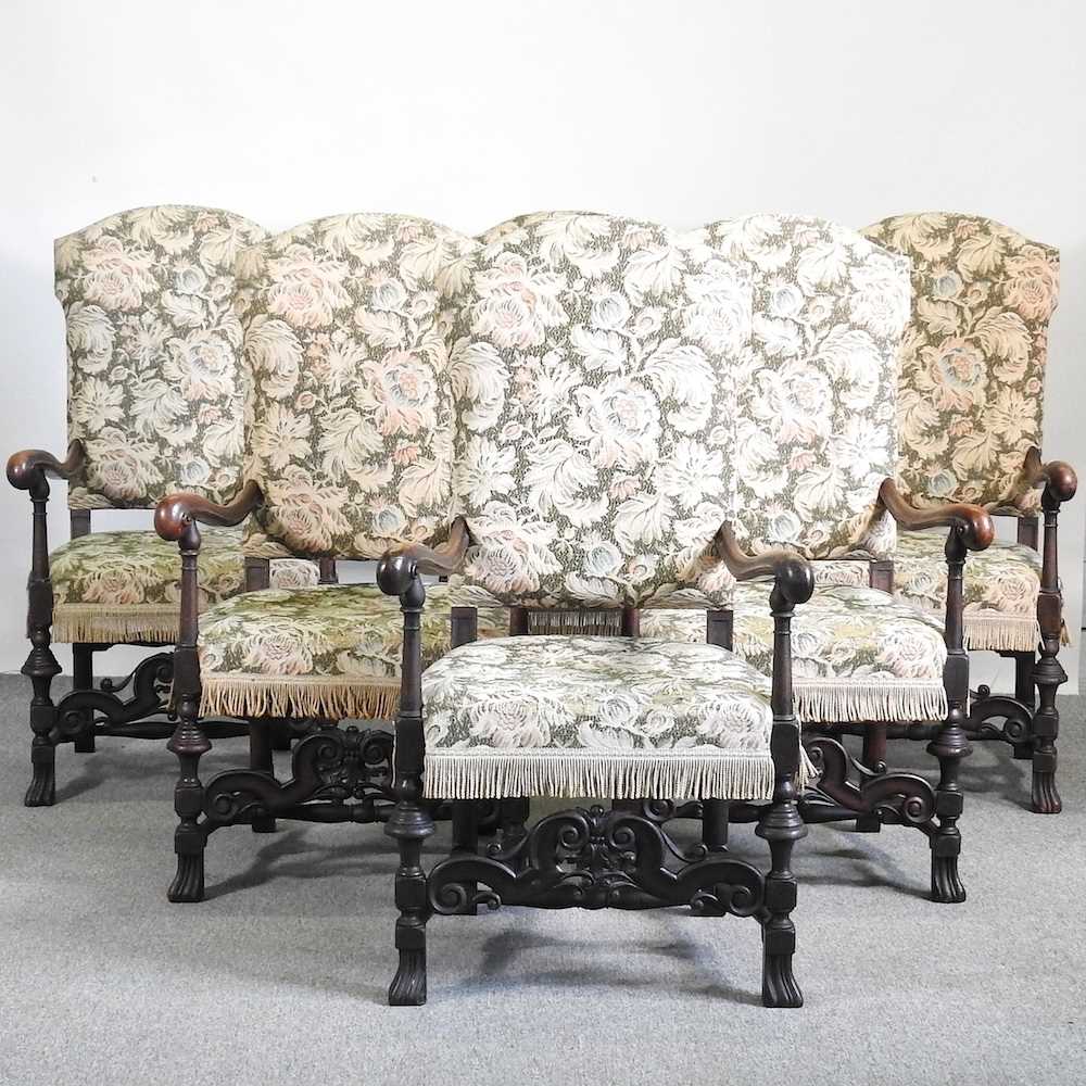 A set of six Carolean style carved walnut elbow chairs, with floral upholstery (6)