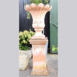 A large terracotta garden urn, of fluted design, with acanthus decoration, on a pedestal base, 148cm